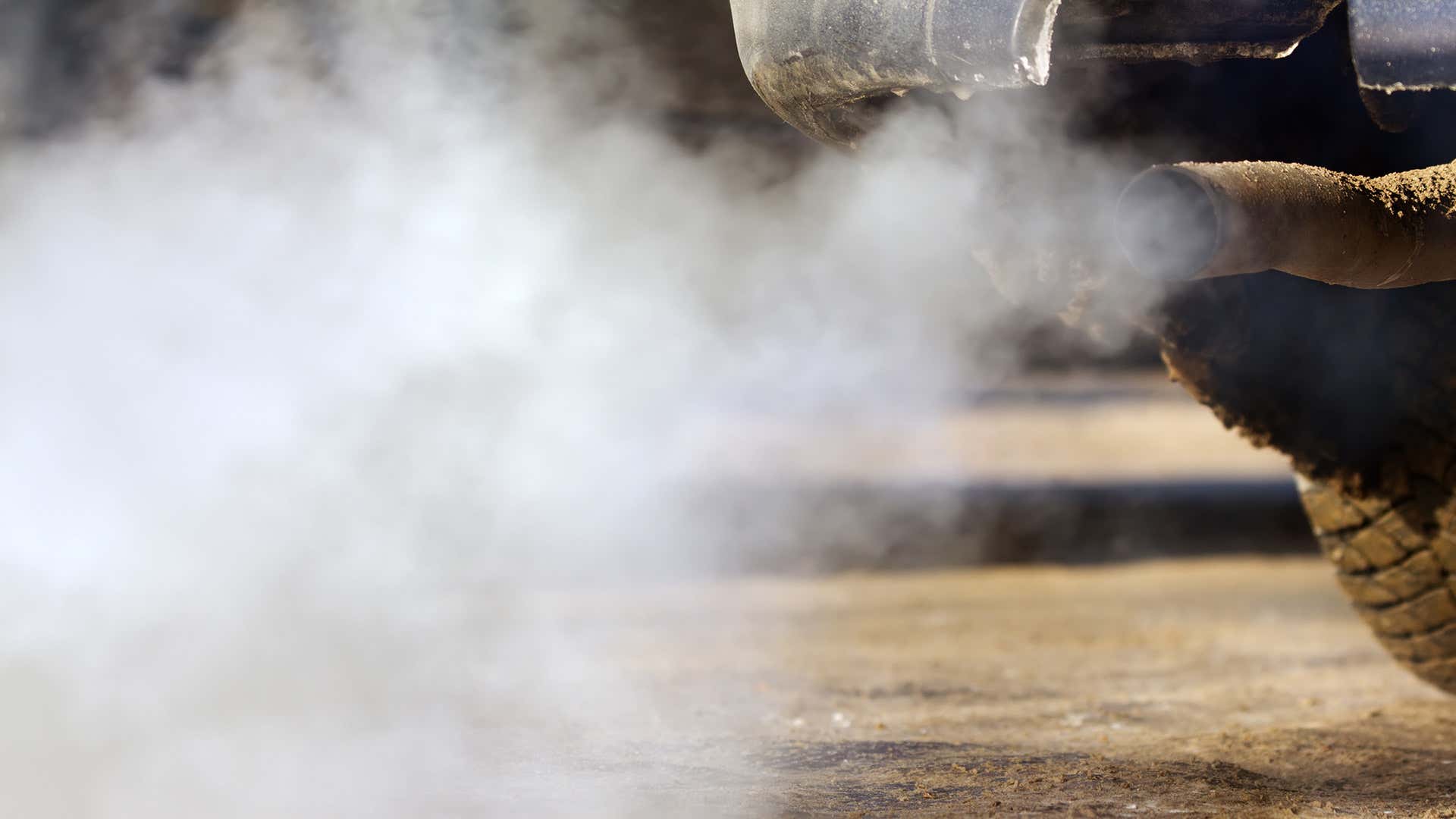 Exhaust fumes trail from an exhaust pipe. 排气管道从排气管道落后。