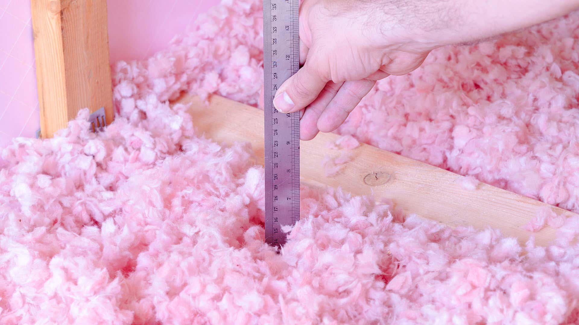 Pink free-form insulation is measured by a ruler. 粉红色的自由形式绝缘由尺子测量。